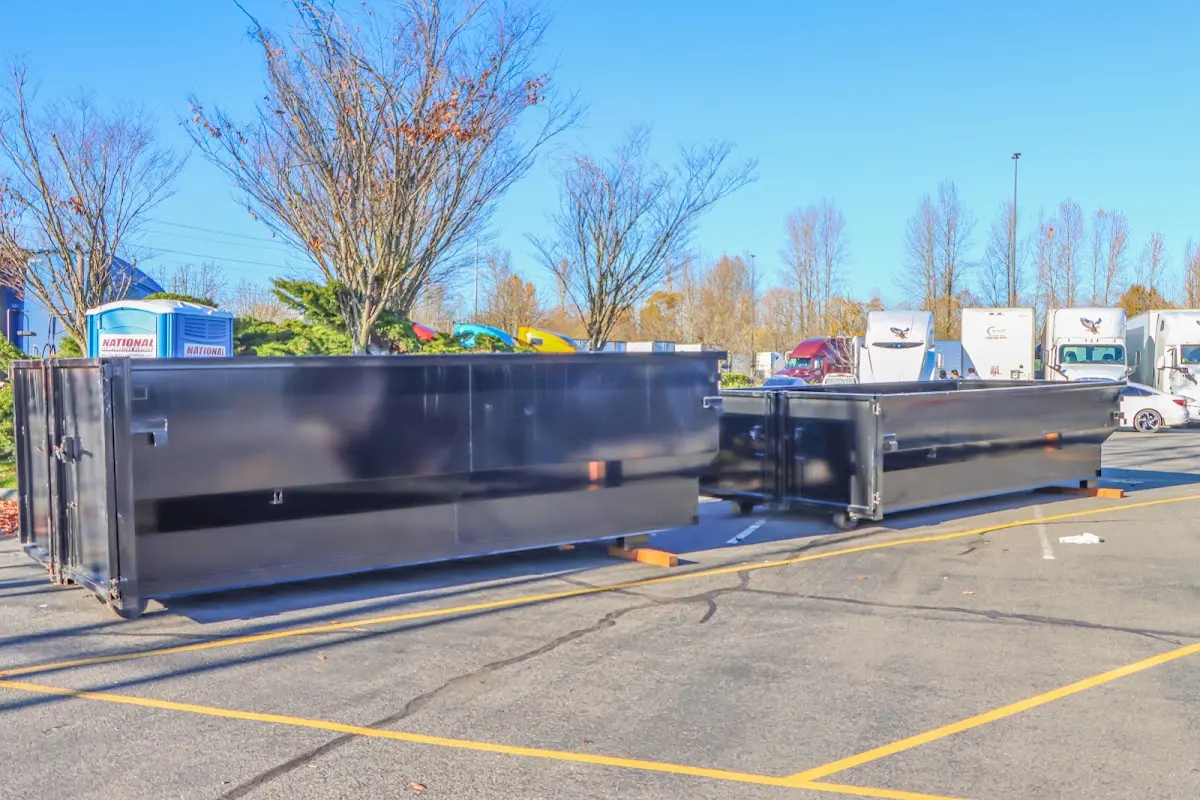 Professional dumpster rental service with roll-off container on residential driveway in Marcy